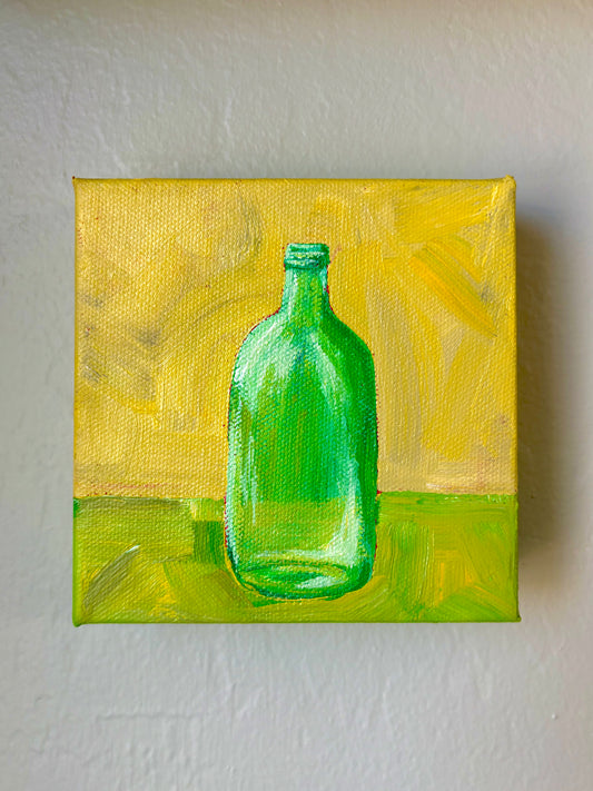 Green Bottle on a Green and Yellow Table