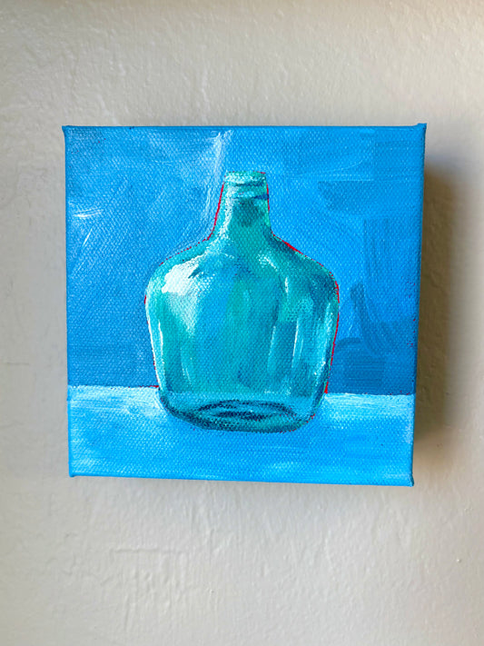 Green bottle on Blue Table